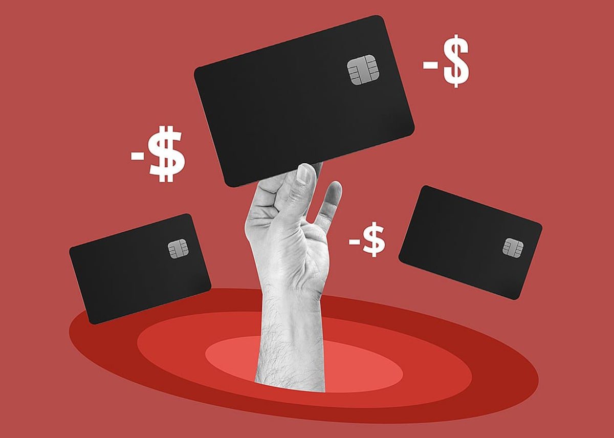 A custom illustration of a hand holding up a credit card - N Universe // Shutterstock