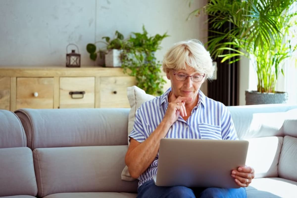 A person on a couch with a laptop