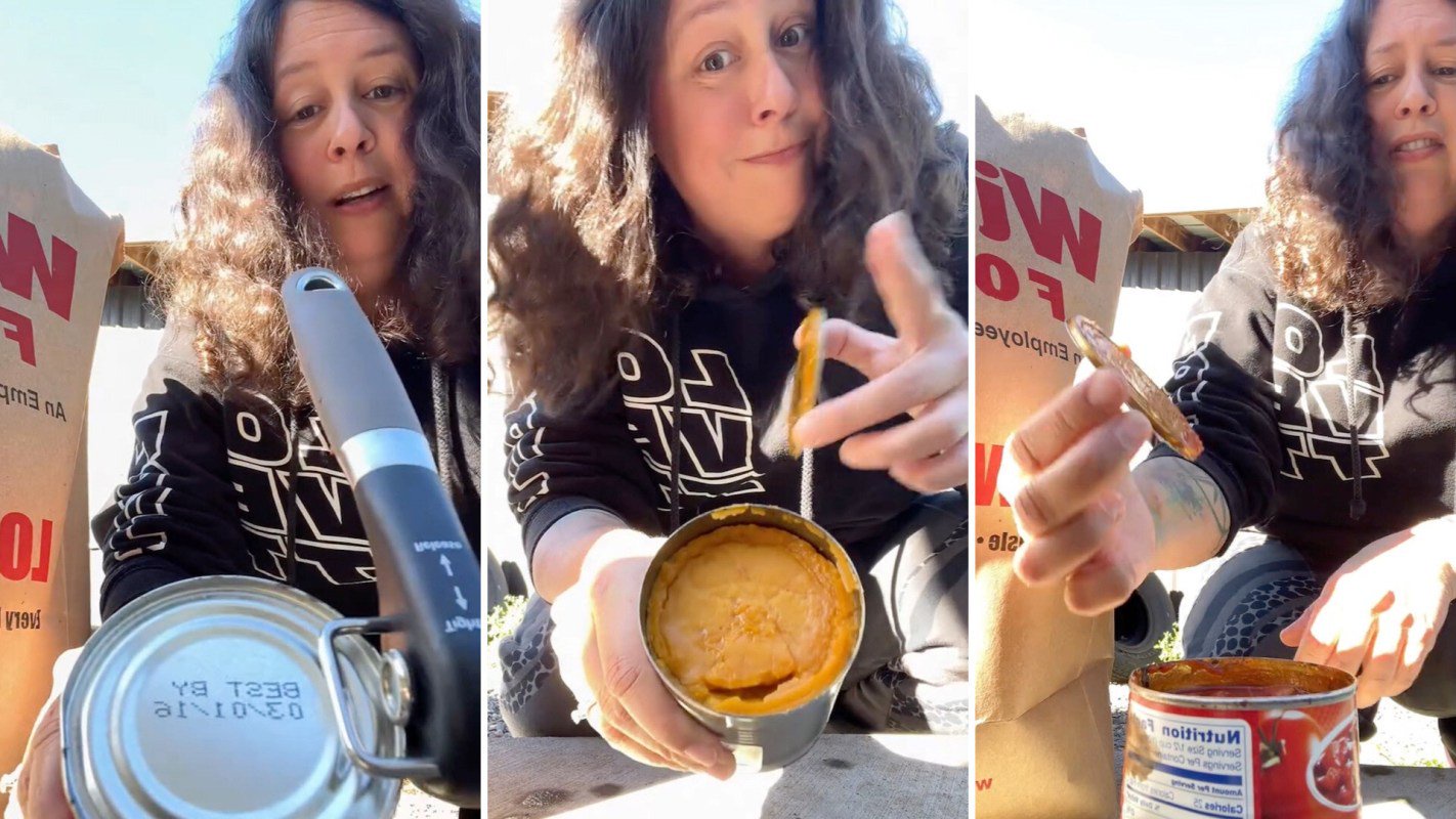 A person opening a can with a can opener.