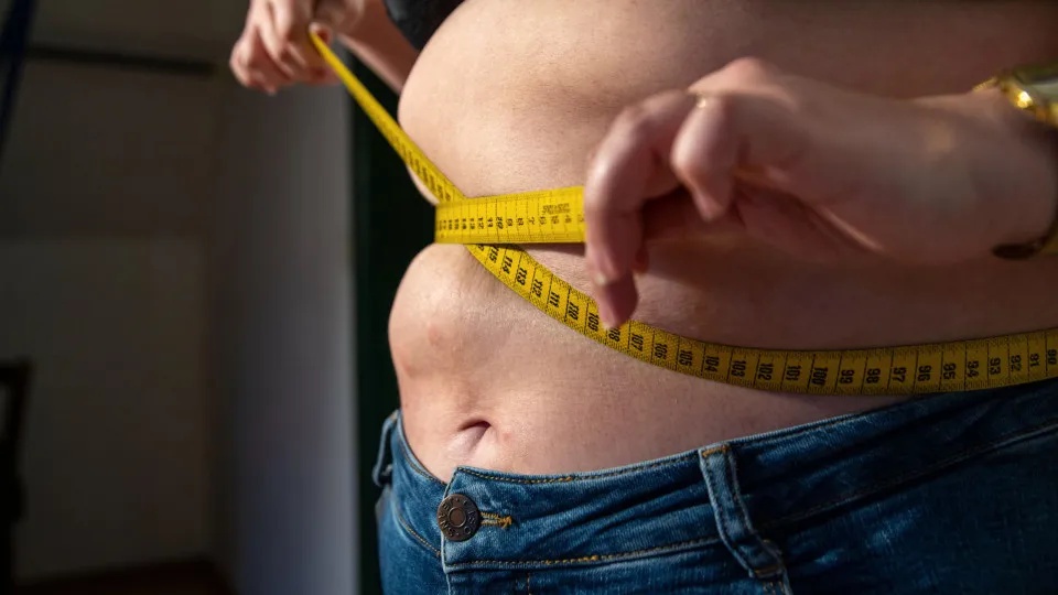 Why do women gain weight around the abdomen?