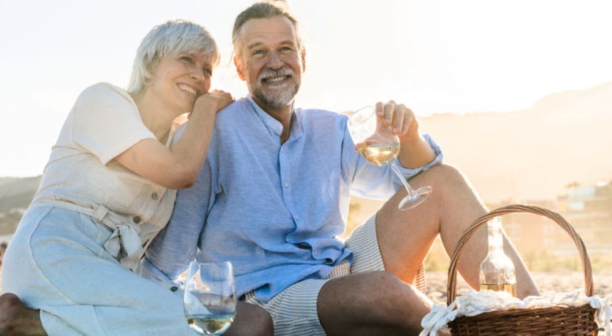 Photo of happy older couple on beach