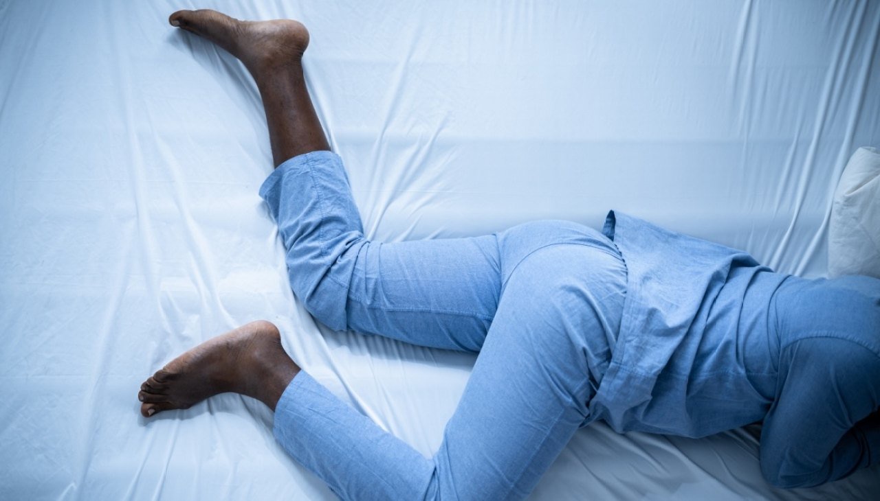 close-up of a woman with restless legs in bed