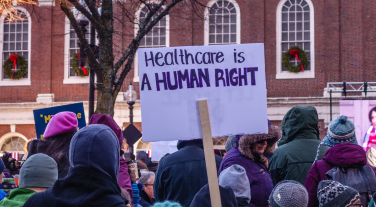 Person holding sign at protest for affordable health care