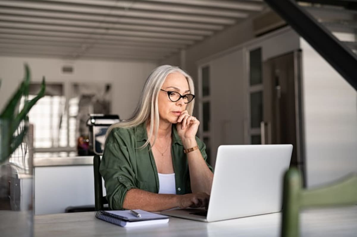 Person staring intently at laptop.