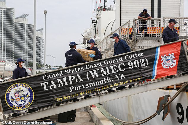 Video shows the moment coast guard members intercepted a boat carrying 5,500 pounds of cocaine worth $94.6MILLION