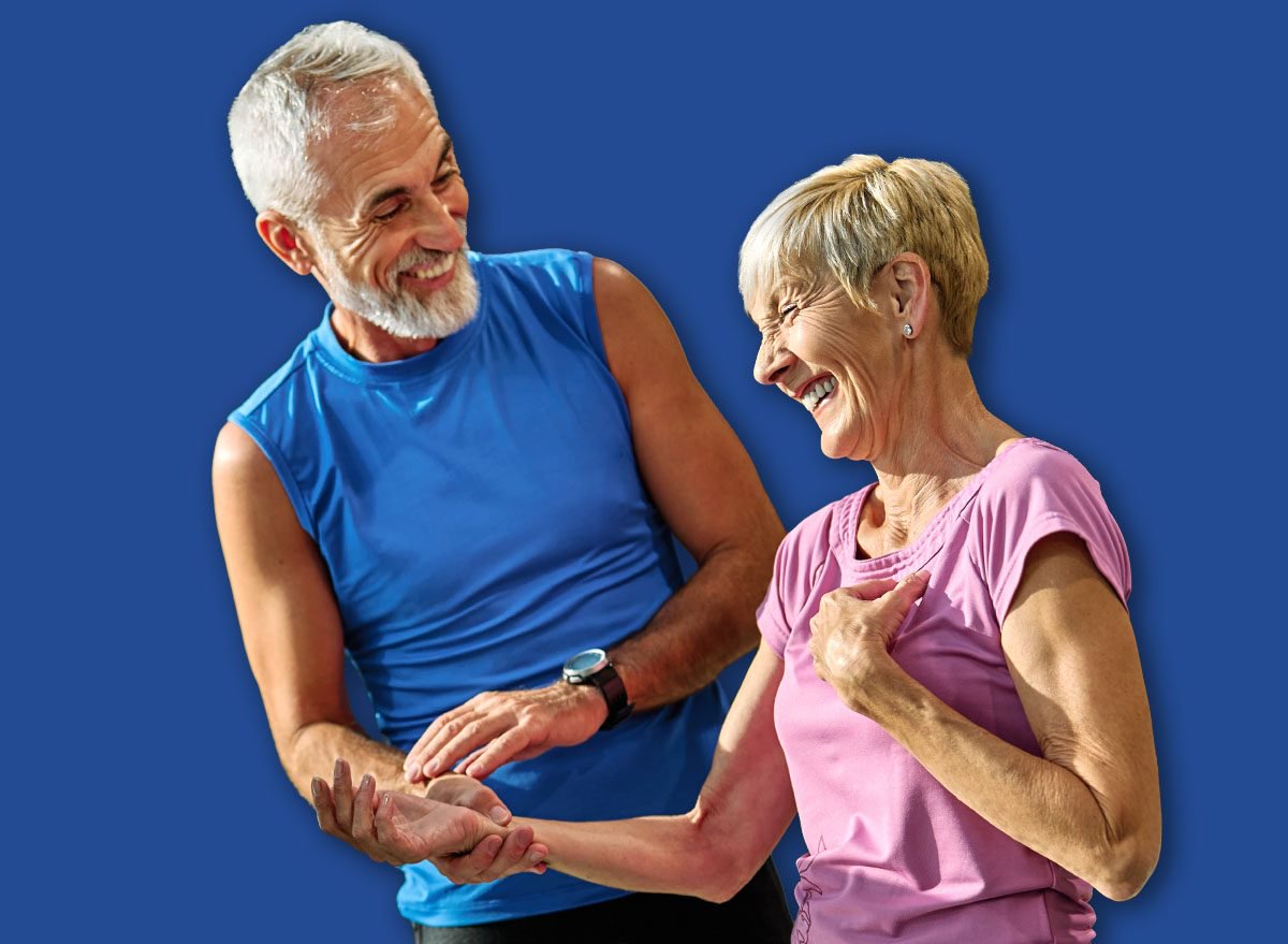 Portrait of a senior couple exercising in a gym, mature couple running using treadmill , healthy lifestyle and cardio vitality and active senior, coach training help and support, checking heartbeat