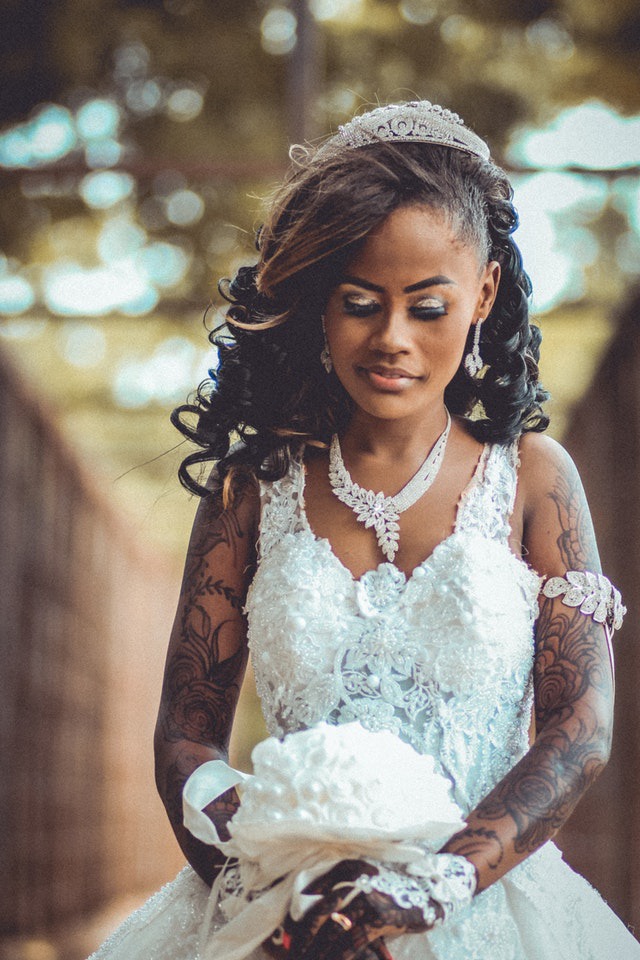 A woman with tattoos in a wedding dress.