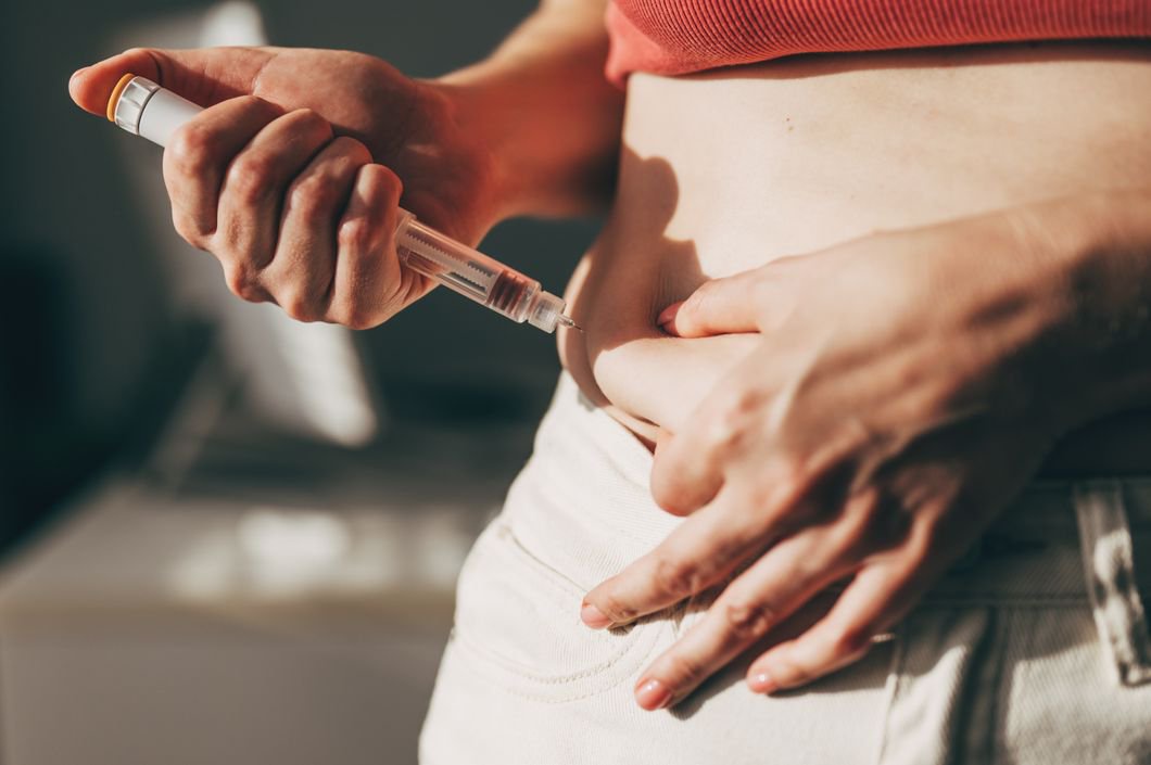 Woman injecting GLP-1 at home