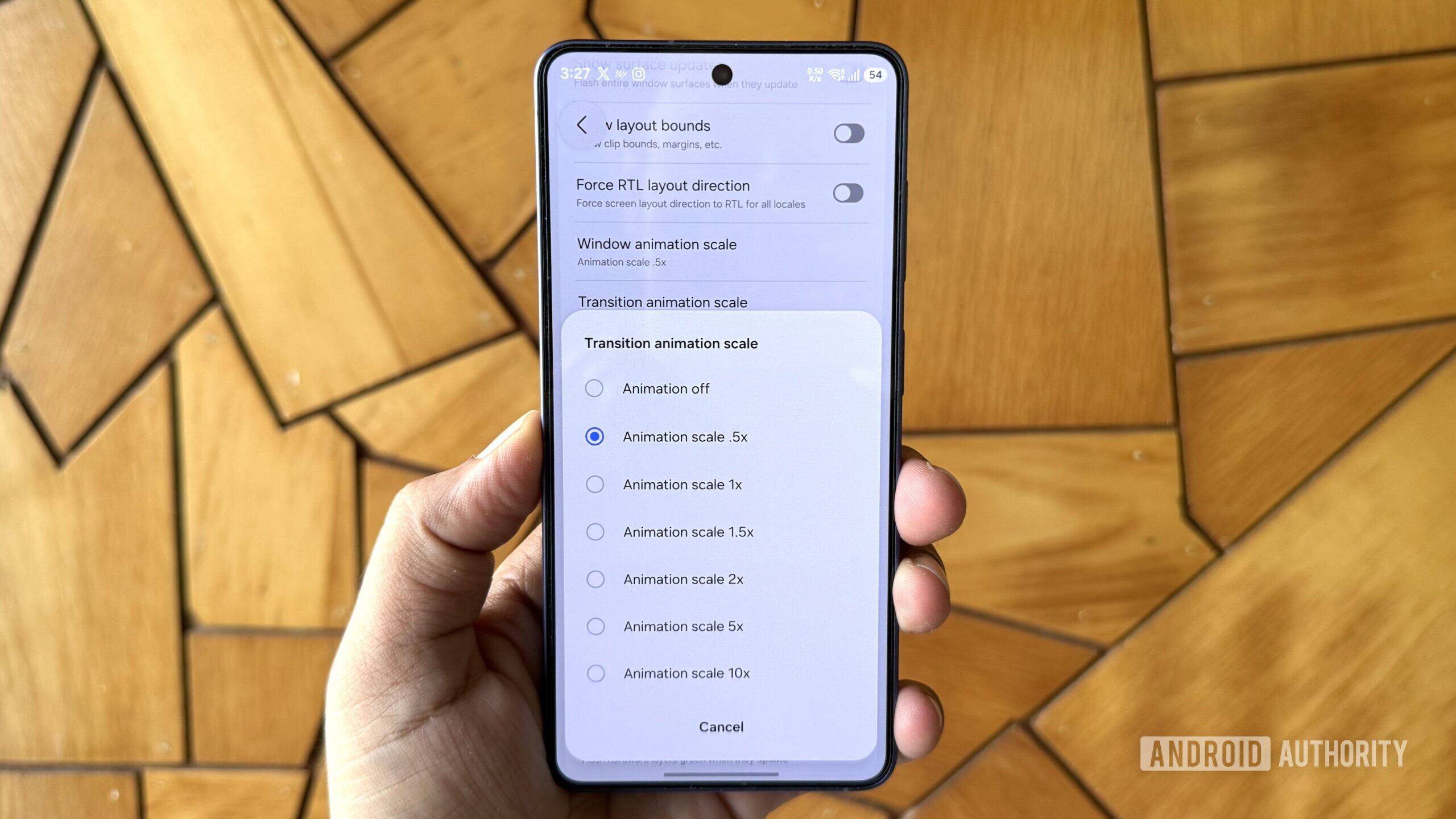Android phone in hand showing app animation scale menu
