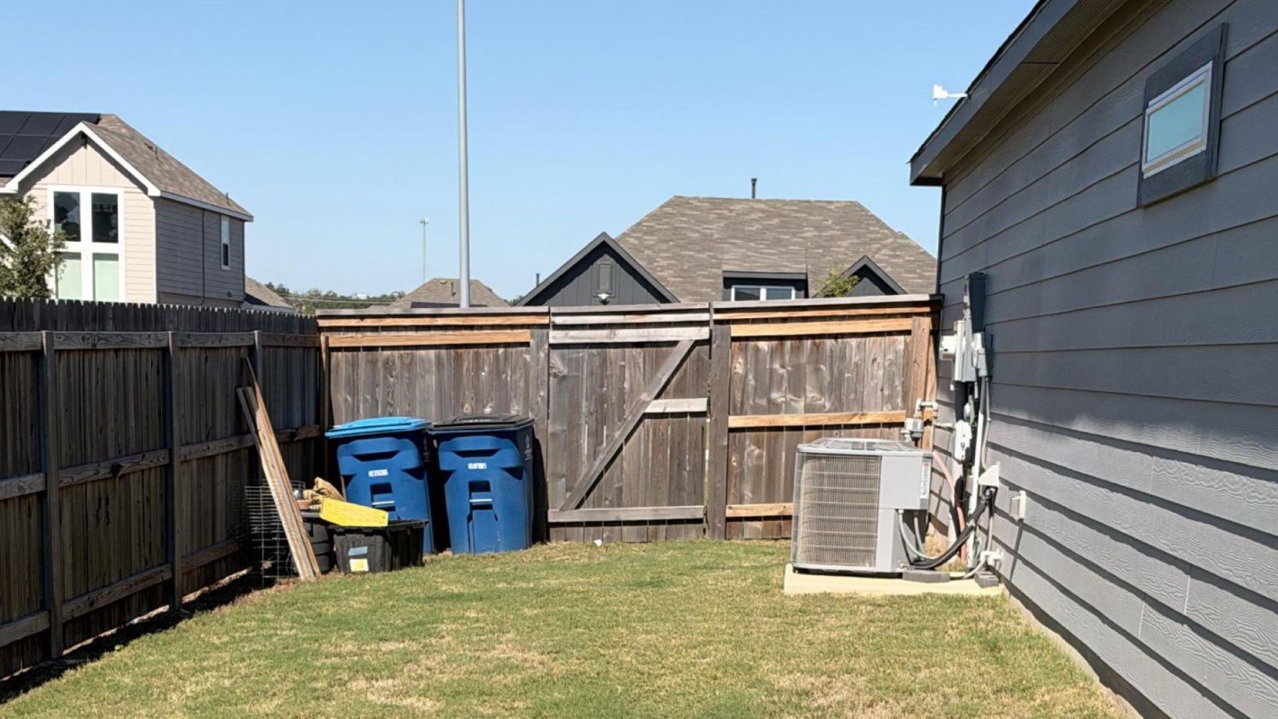 A generator in a fenced yard.