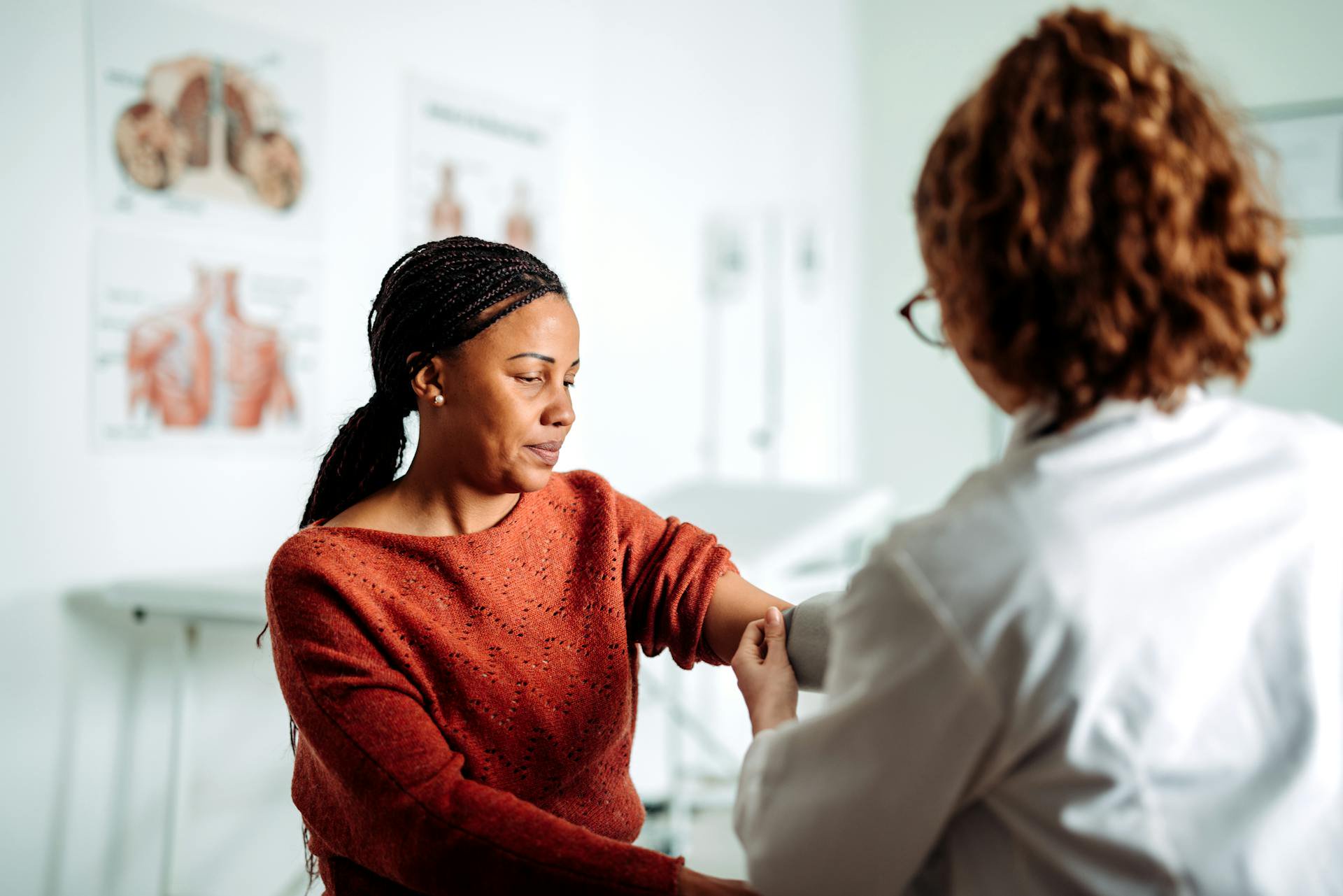 A woman has her blood pressure taken at the doctor's office.