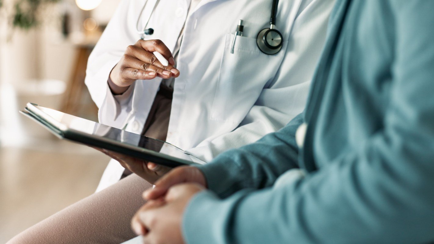A healthcare professional discusses a treatment plan with a patient.