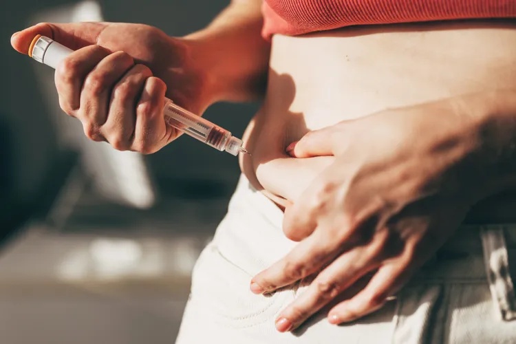 Woman injecting GLP-1 at home