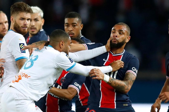 Marseille's Jordan Amavi clashes with PSG's Layvin Kurzawa.