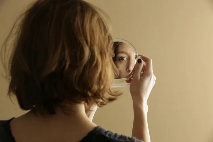 Stock, Woman lookin in mirror