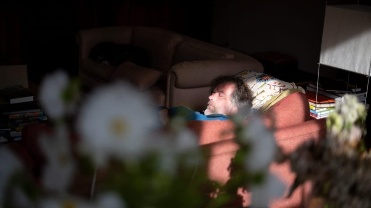 mature white man napping on sofa
