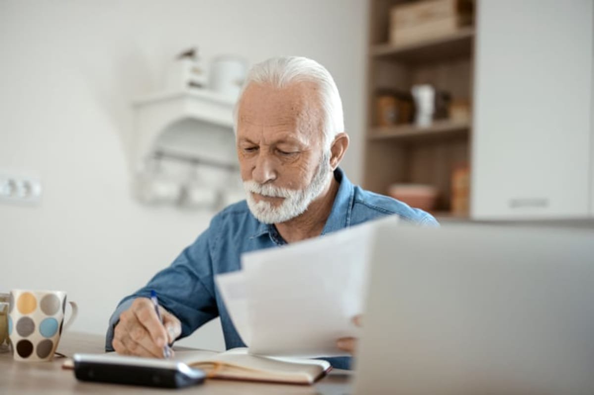 A person at a table holding documents