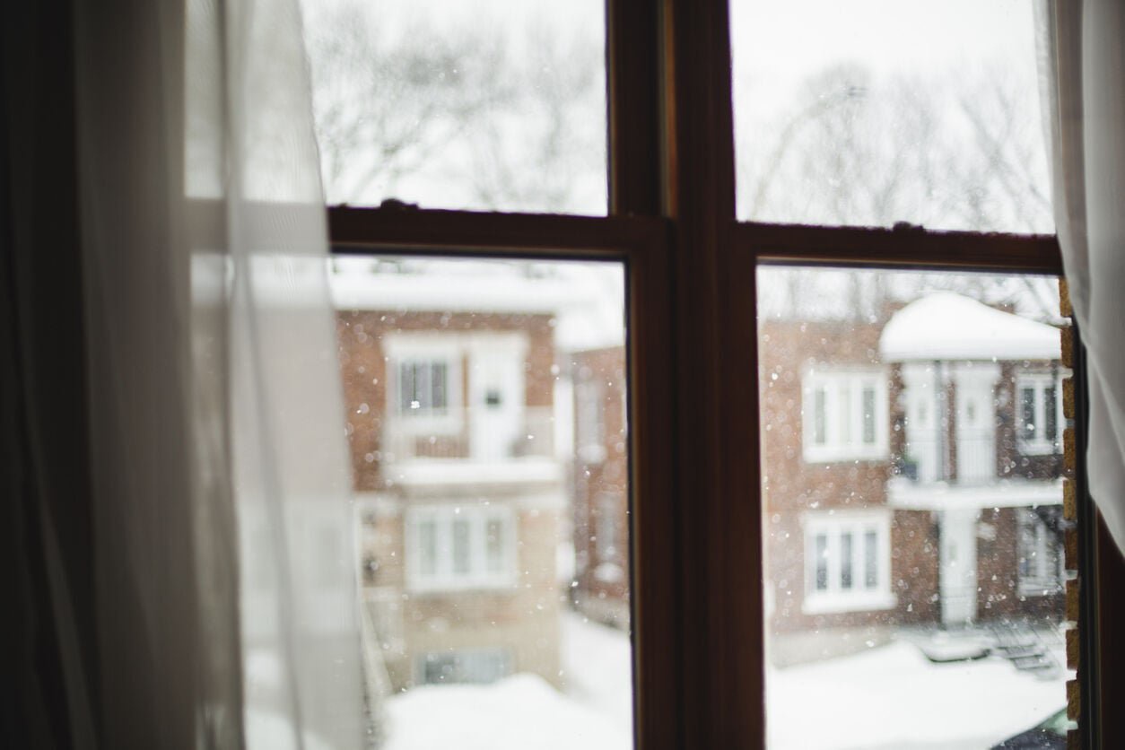 Snow falling through a window