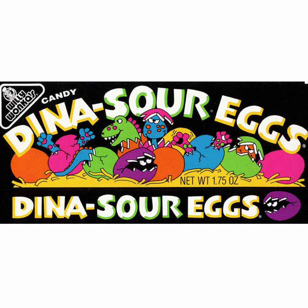 Colorful candy packaging for Willy Wonka's Dina-Sour Eggs featuring cartoon dinosaurs and eggs on a black background.