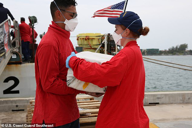 Video shows the moment coast guard members intercepted a boat carrying 5,500 pounds of cocaine worth $94.6MILLION