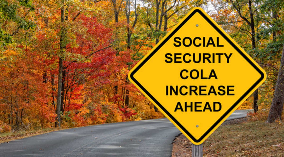 A road sign stating "Social Security COLA Increase Ahead" with fall foliage in the background.