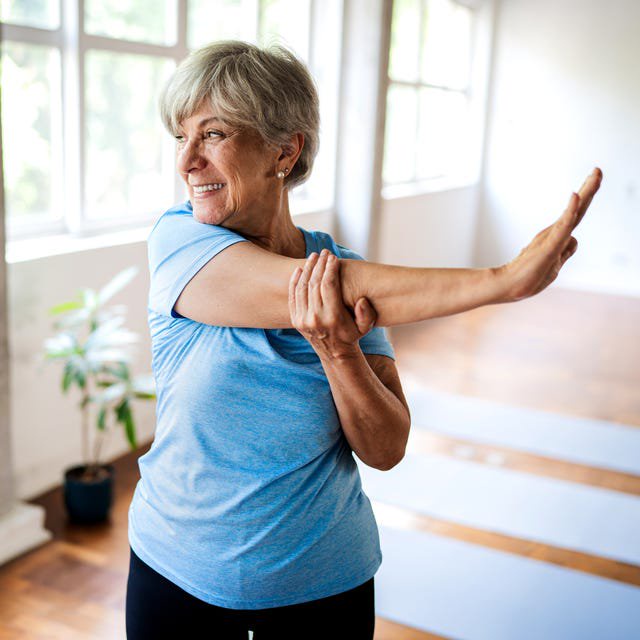 An older woman stretching