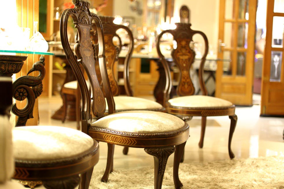 Empty vintage dining chairs in dining room.