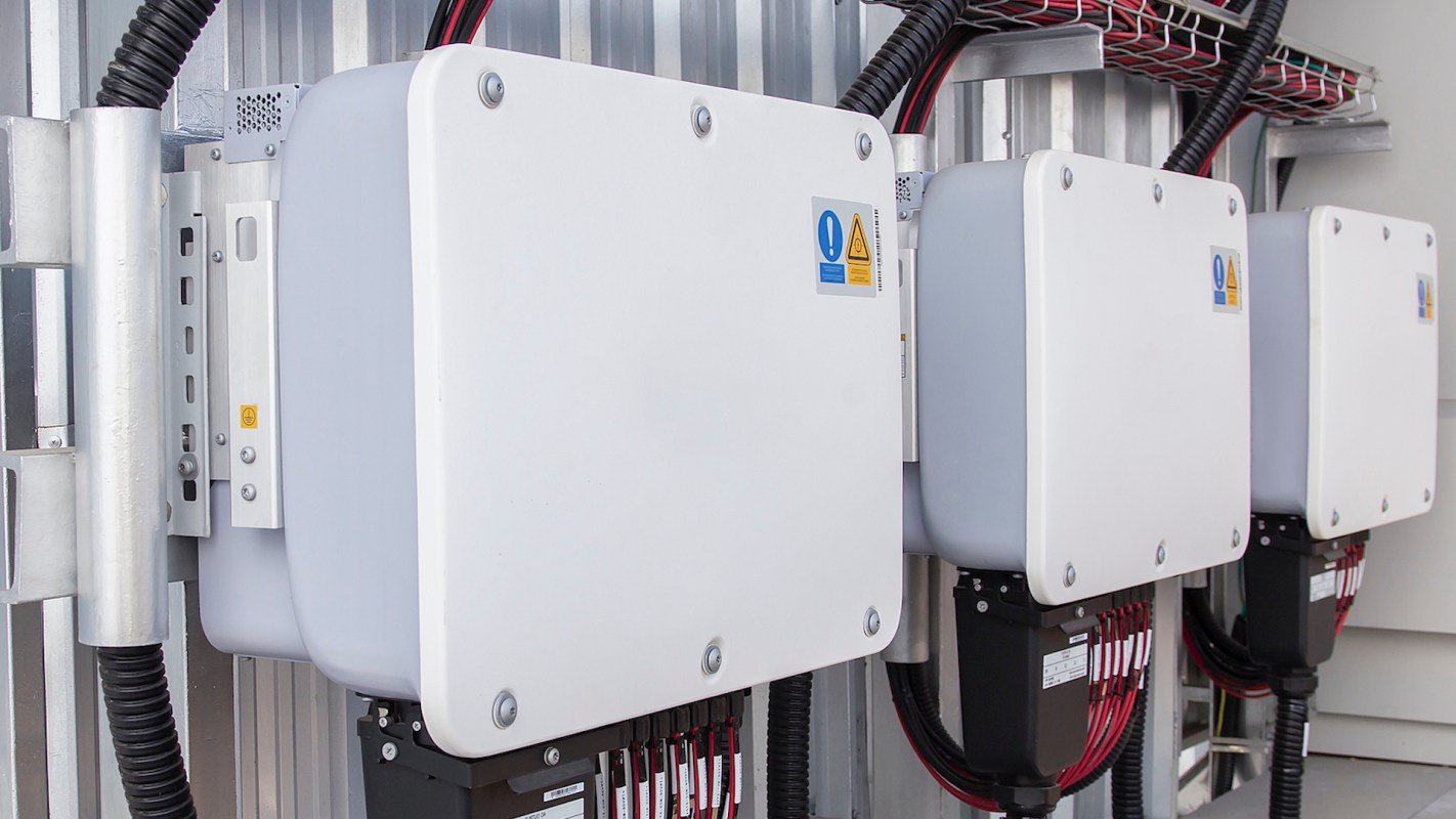 Three battery storage units mounted on a wall.