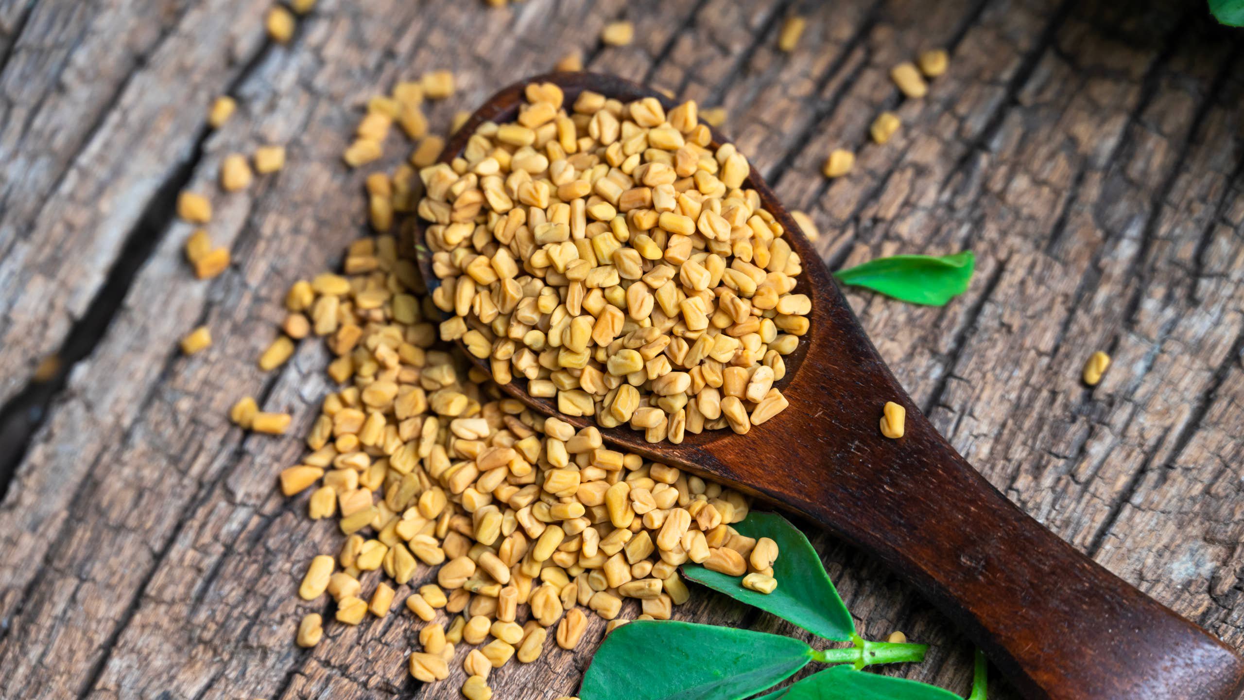 fenugreek seeds on wooden background