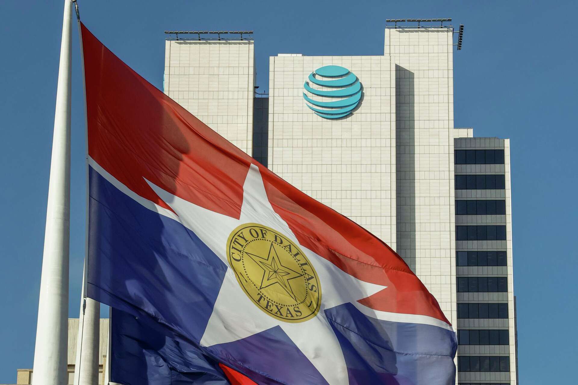 A City of Dallas flag flies in front of AT&T headquarters building Whitacre Tower in downtown Dallas, Monday, Jan. 5, 2026.
