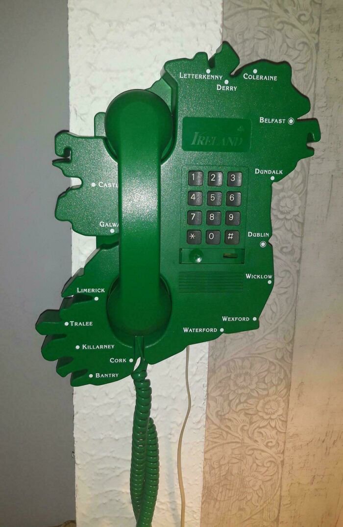 A green wall-mounted landline phone shaped like Ireland, showcasing unique retro gadgets technology