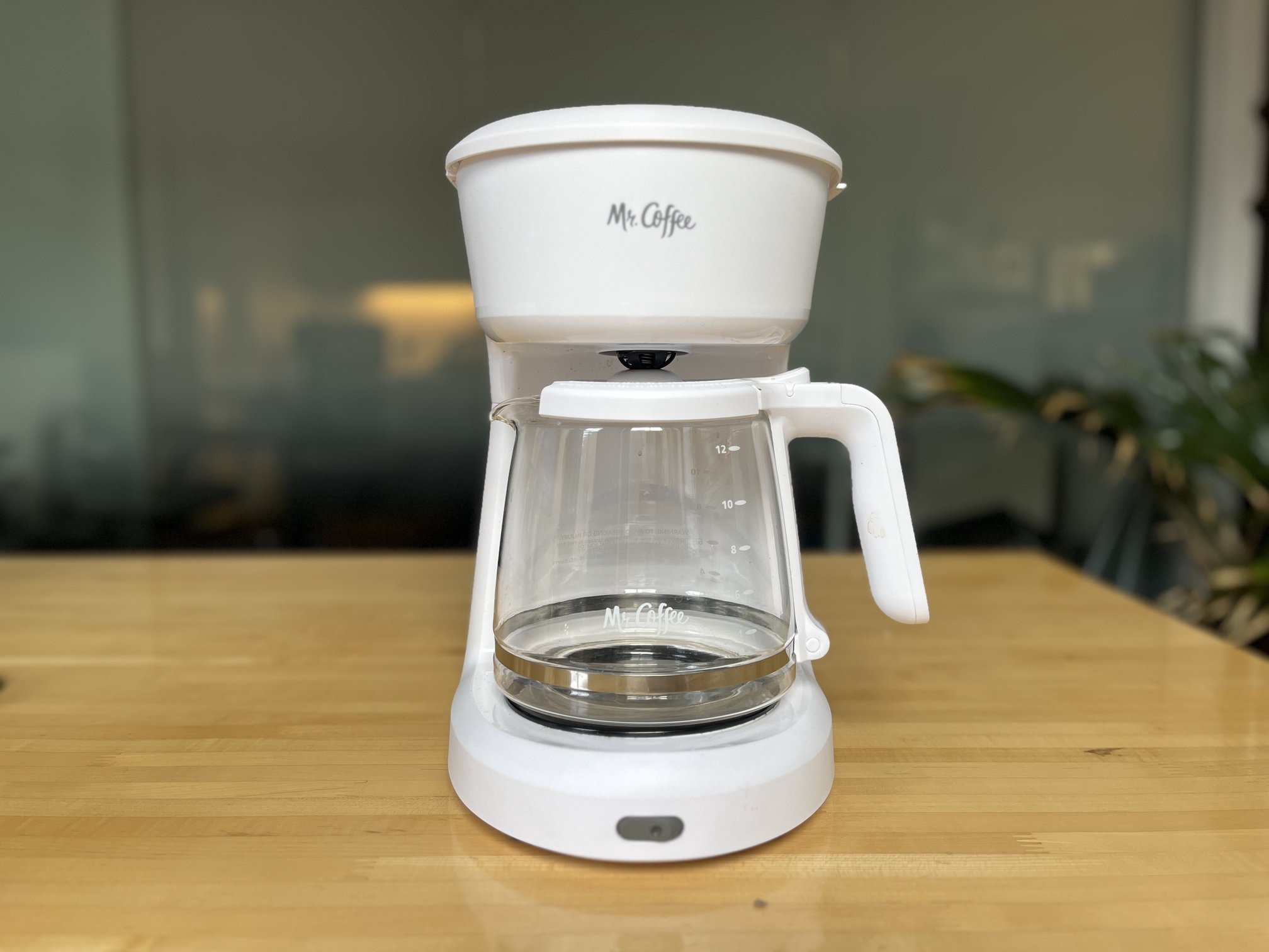 white drip coffee maker on a wooden table