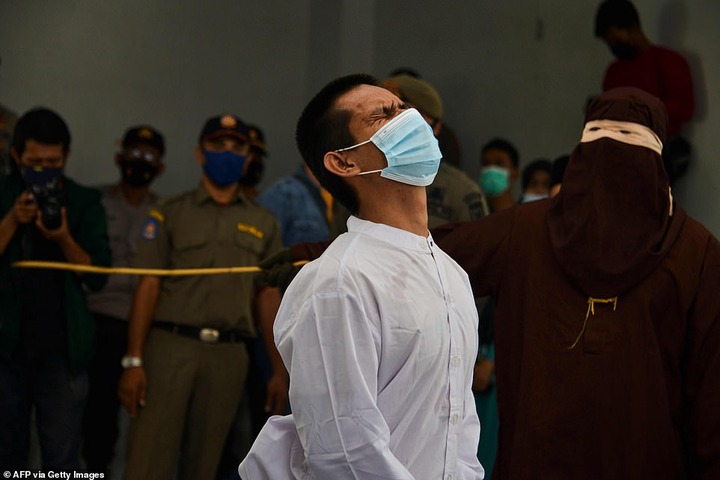Two gay men are caned 77 times each in Indonesia after they were caught having s3x (Photos/Video)