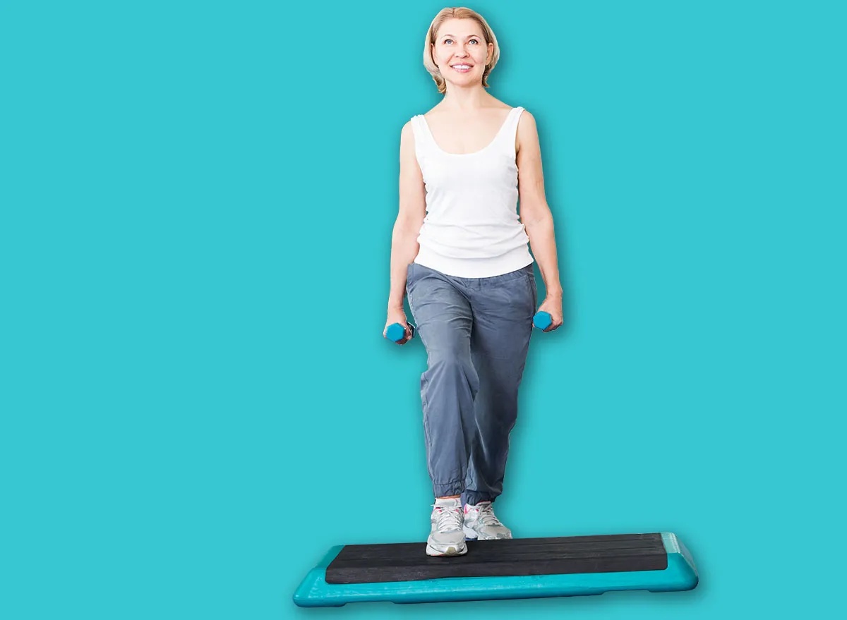 Mature happy people do pilates in a sport club with dumbbells