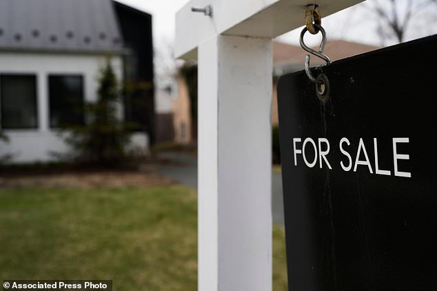 FILE - A House For Sale sign is displayed in front of a home in Evanston, Ill., Wednesday, March 25, 2026. (AP Photo/Nam Y. Huh, File)