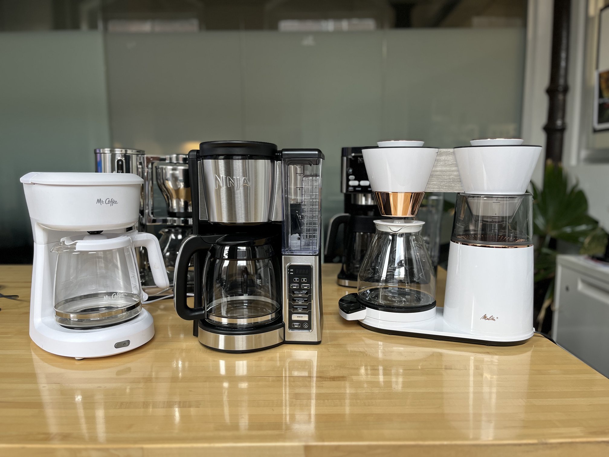 multiple coffee makers sitting on a table