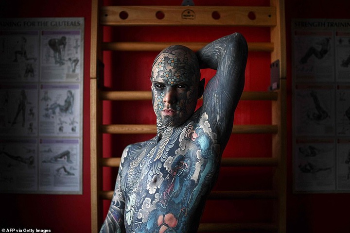  French primary school teacher who spent ?35k covering his body in tattoos is banned from kindergarten because he gives children nightmares (photos)