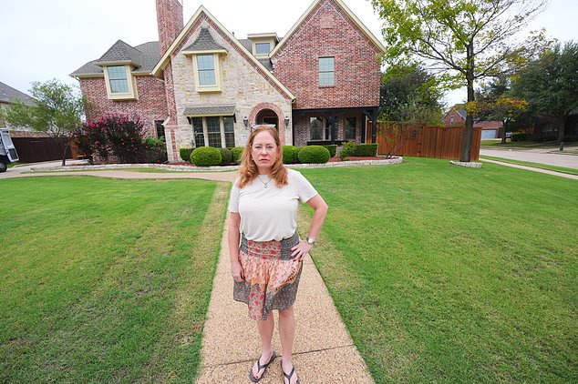 Liz Suder poses for a photo in front of her former home that was sold in Murphy, Texas, Tuesday, Oct. 13, 2026. (AP Photo/LM Otero)