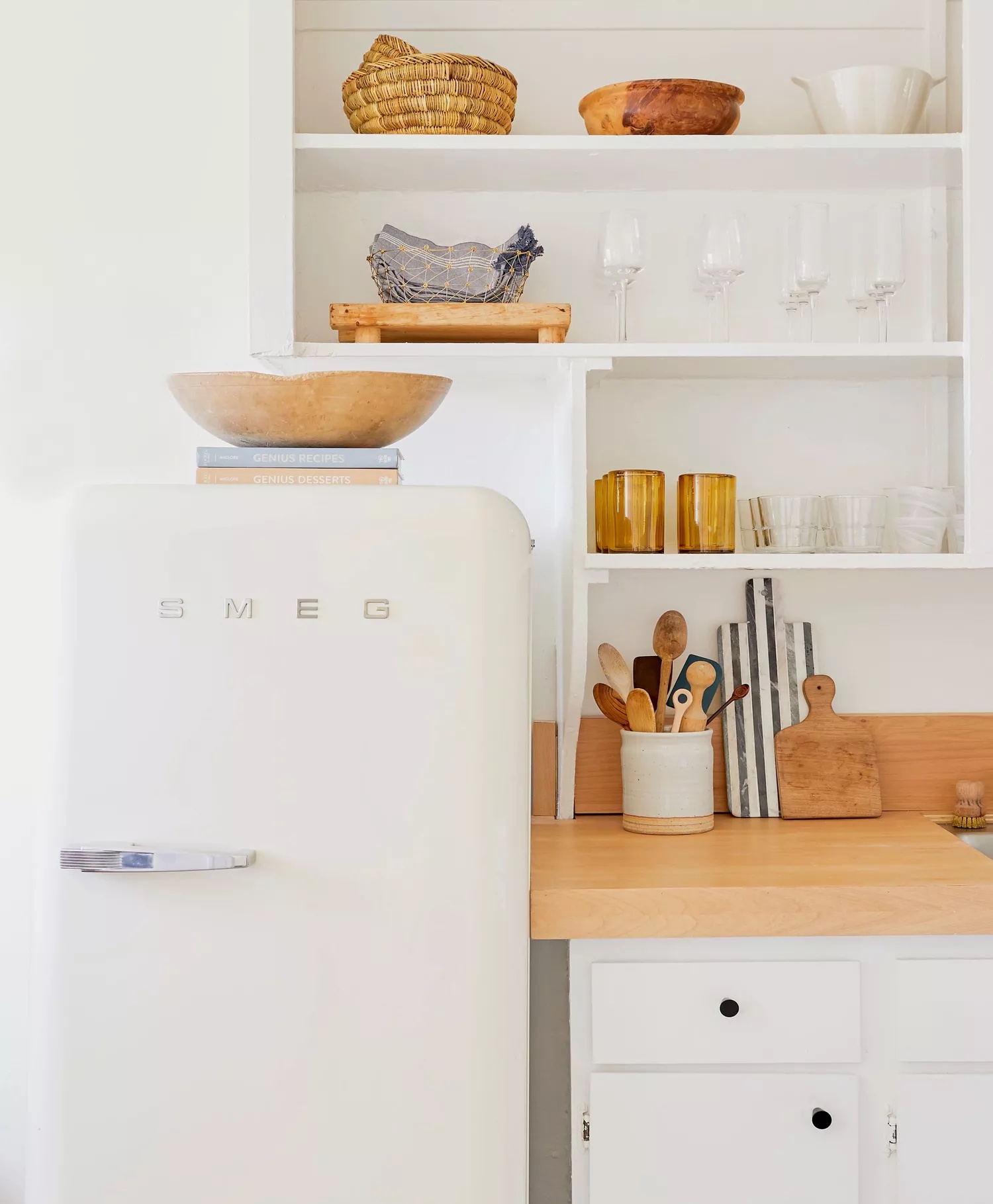white modern kitchen with retro fridge cookbooks and bowl on top of fridge