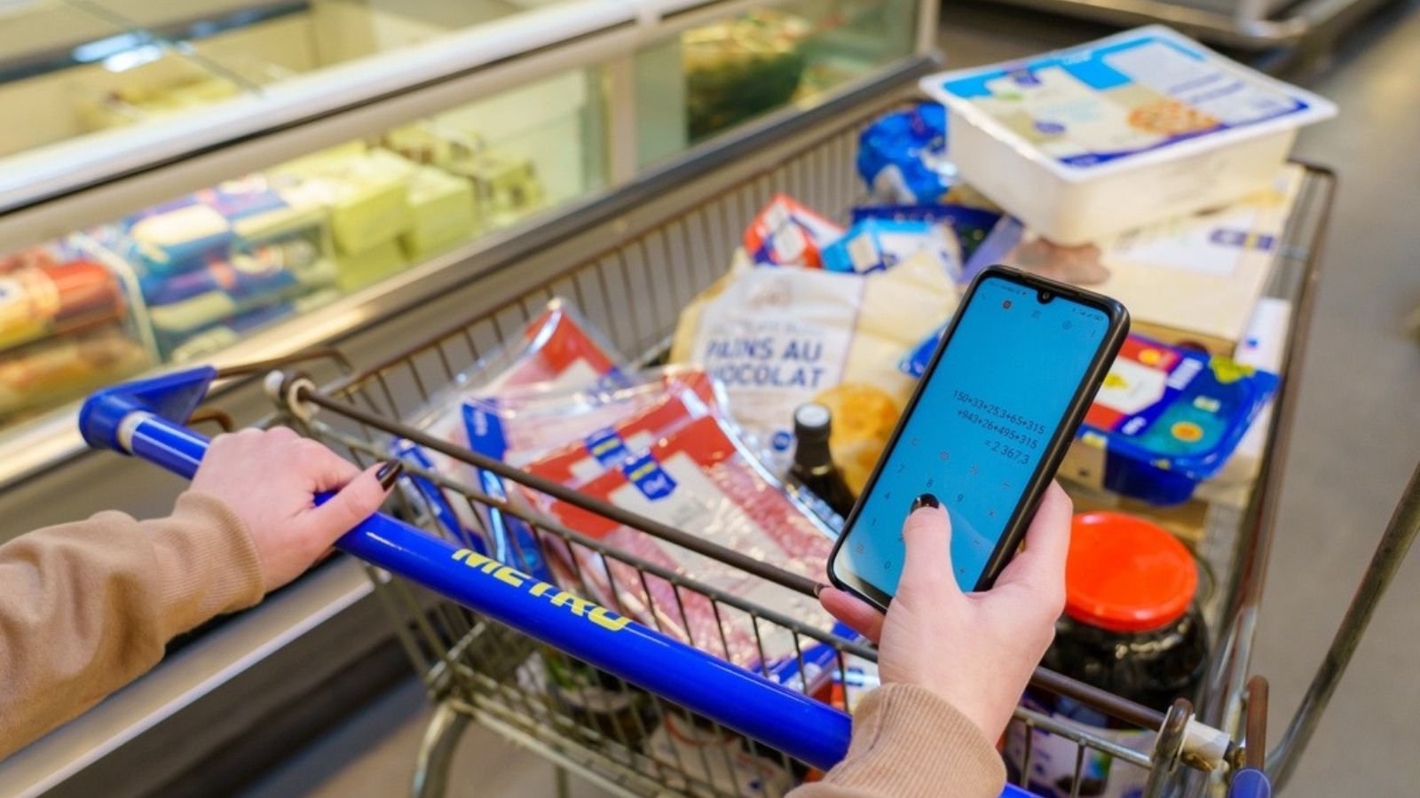 grocery shopping with calculator on phone