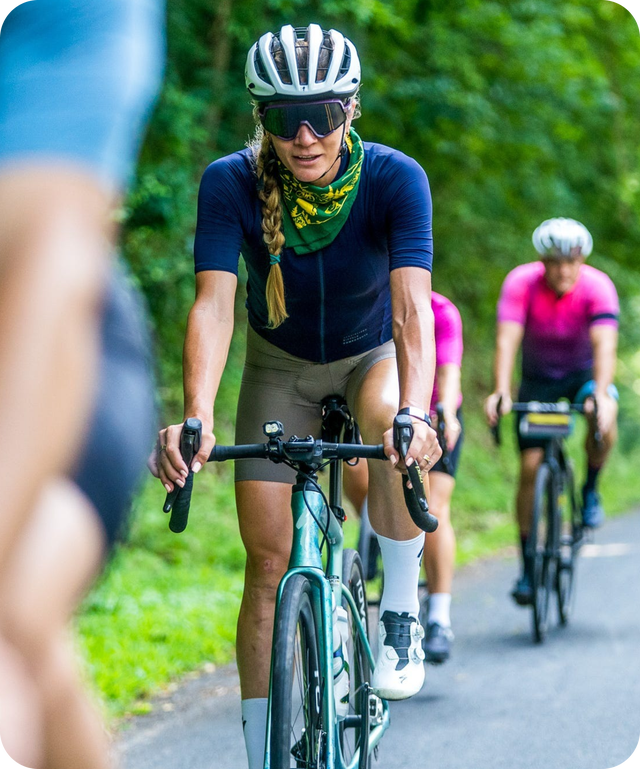 cyclist riding down road in group