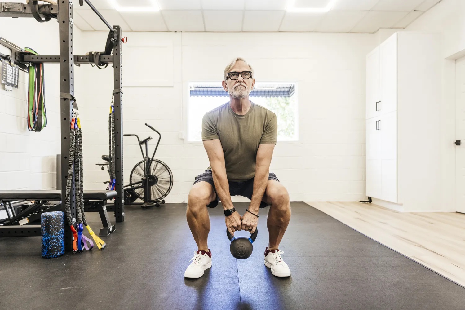 A man practicing resistance training with a kettle bell