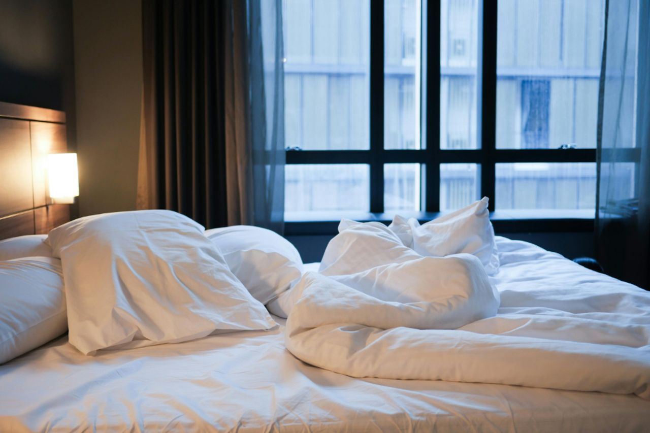 Photo of a bed in a hotel room.