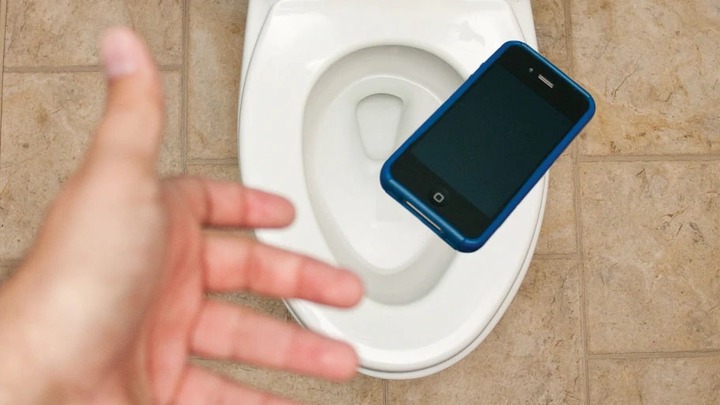 Pressing Phone inside the Toilet