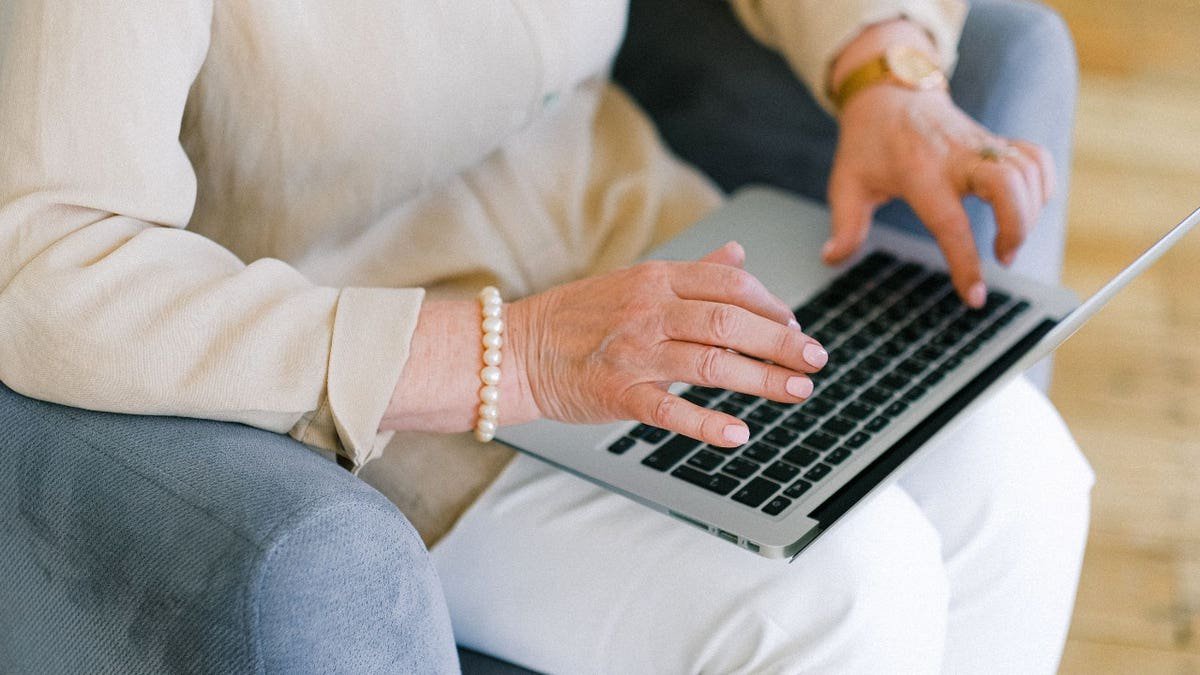 A person typing on a laptop