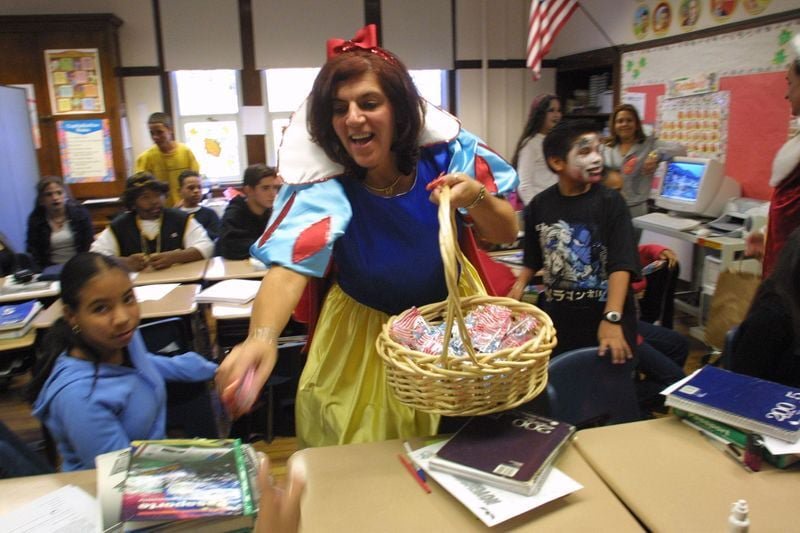 School principal JoAnne Riviello, as Snow White, tours classrooms distributing Halloween candy on October 31, 2002.