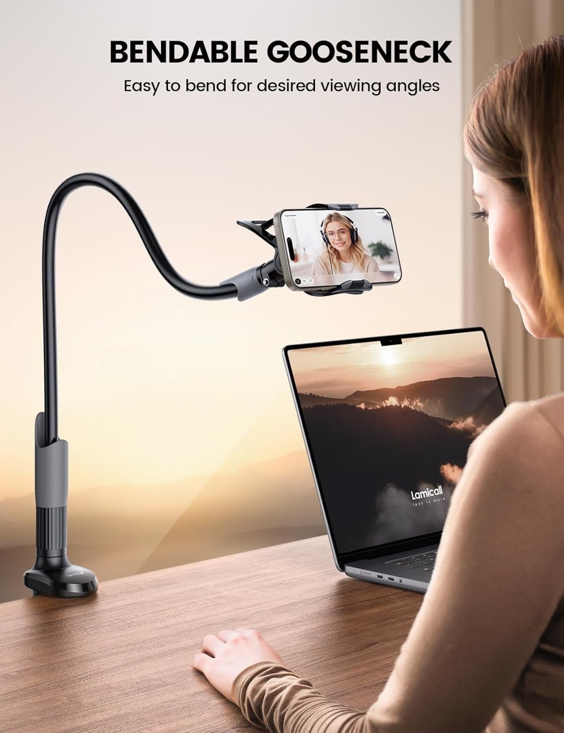 Person using a bendable gooseneck phone holder attached to a desk, allowing hands-free video viewing while working on a laptop