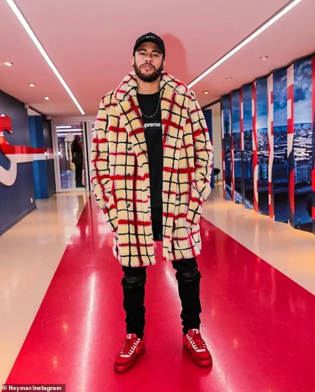 Paris Saint-Germain star Neymar poses for a picture while showing off his big winter coat