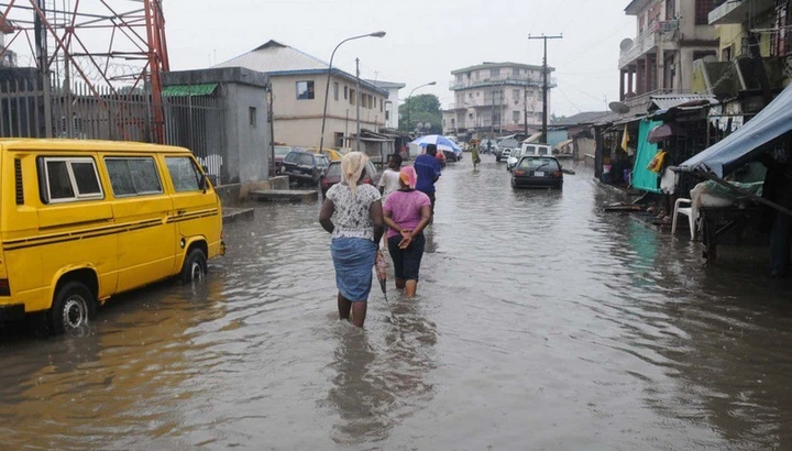 Residents trudge in flood water in Lagos (Illustrative. Punch)