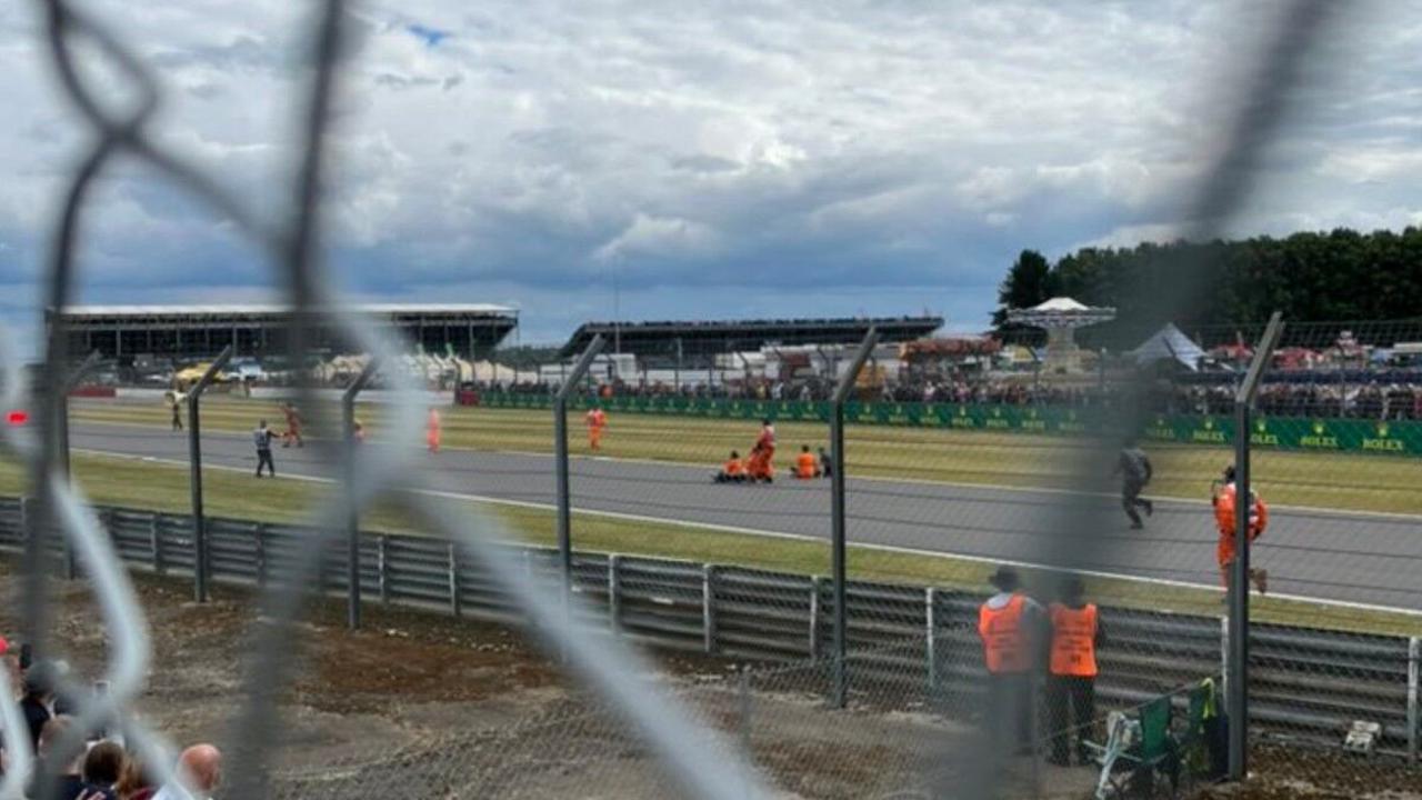 British GP first lap bursts into madness as protestors storm the track after huge crash